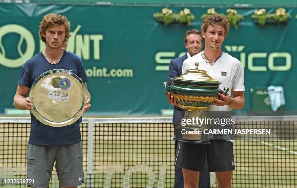 Winner France's Ugo Humbert and second Russia's Andrey Rublev pose with the trophy after their final match at the ATP 500 Halle Open tennis...