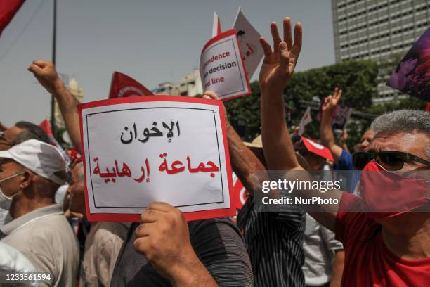Protester raises a placard that reads in Arabic, the Muslim Brotherhood's Supreme in a terrorist group, during a demonstration held by the PDL party...