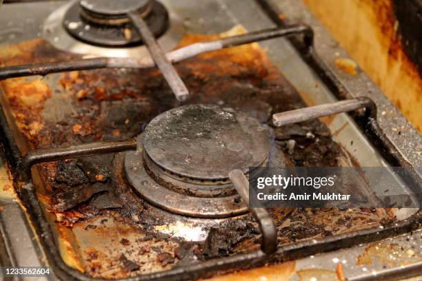 dirty domestic gas stove in kitchen. - burnt cooking stock pictures, royalty-free photos & images