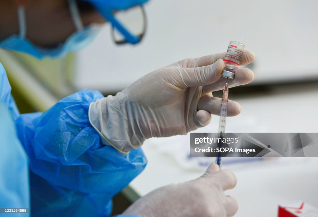 A health worker prepares to administer a dose of Sinopharm...