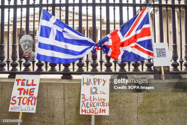 The UK and Greek flags as well as placards placed outside the British Museum during the protest. The British Committee for the Reunification of the...