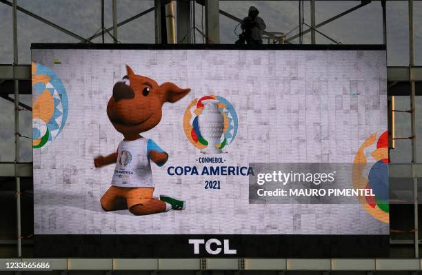 The mascot of the Conmebol Copa America 2021 football tournament, "Pibe", is seen on a screen before the group phase match between Venezuela and...