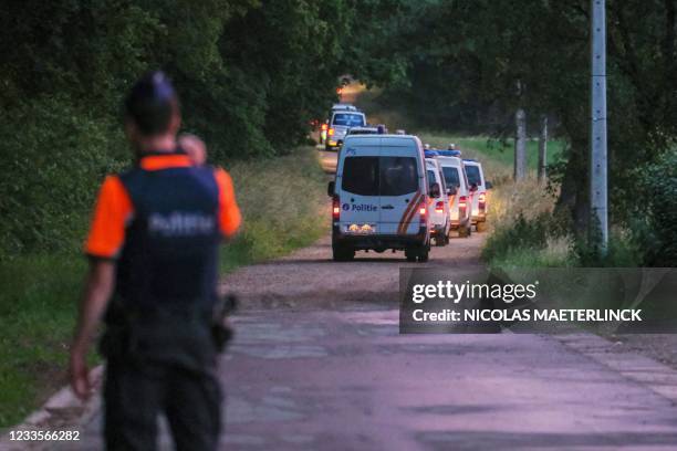 Police vehicles arrive to patrol the spot where the body of Jurgen Conings was found in the Dilserbos, a forest area of Nationaal Park Hoge Kempen in...