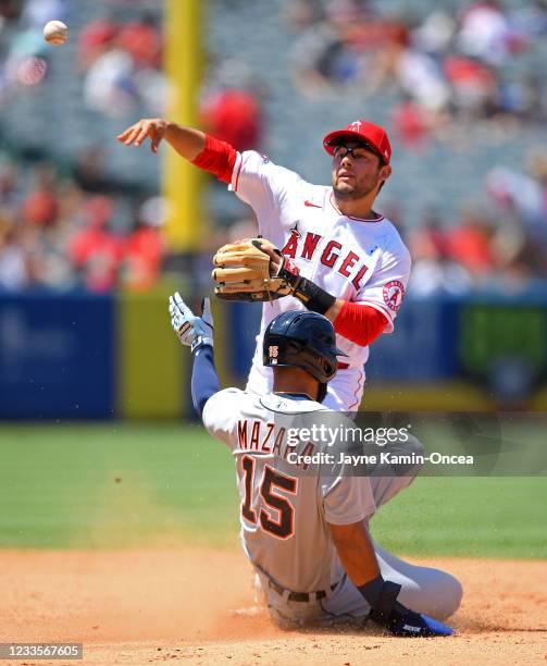 David Fletcher of the Los Angeles Angels throws to first as Nomar Mazara of the Detroit Tigers is out on a double in the fourth inning of the game at...