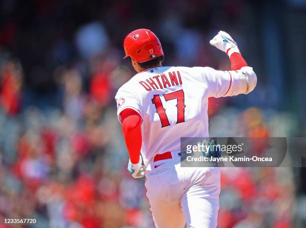 Shohei Ohtani of the Los Angeles Angels pumps his fist as he rounds the bases after hitting a two-run home run in the fifth inning of the game...
