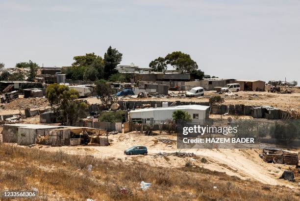 This picture taken on June 8, 2021 shows a view of houses in the unrecognised bedouin village of Sawaneen in Israel's southern Negev Desert. - The...