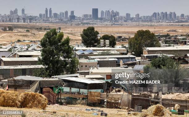 This picture taken on June 8, 2021 shows a view of houses in the unrecognised bedouin village of Sawaneen in Israel's southern Negev Desert. - The...