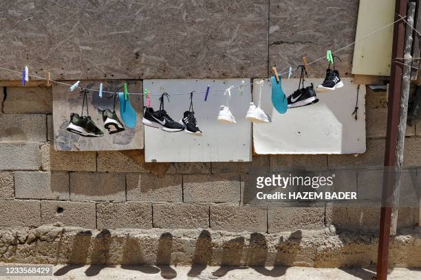 Sneakers are hung on a laundry line to dry out in the sun at a home in the unrecognised bedouin village of Sawaneen, in Israel's southern Negev...