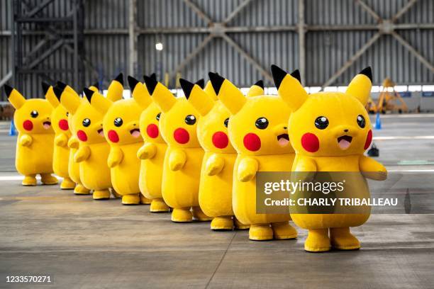 Pikachu mascots are seen during the unveiling of new Pokemon-themed livery on a Skymark Airlines Boeing 737-800 aircraft at Tokyo's Haneda...