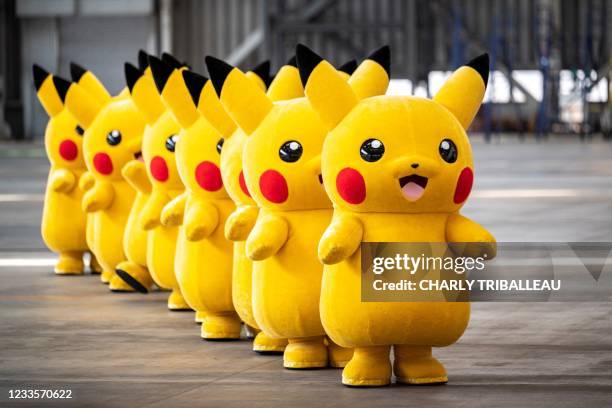 Pikachu mascots are seen during the unveiling of new Pokemon-themed livery on a Skymark Airlines Boeing 737-800 aircraft at Tokyo's Haneda...
