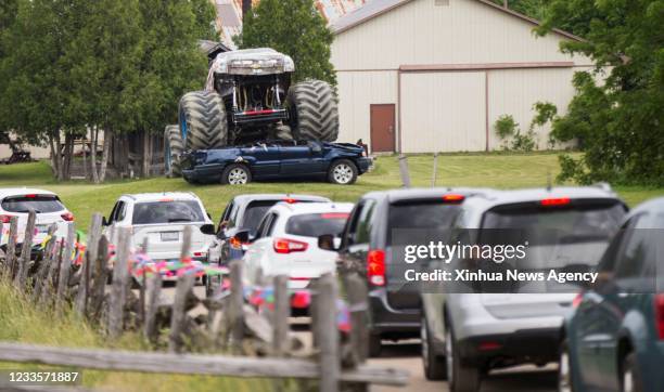 People drive their vehicles to attend the 2021 Mega Wheels Drive-Thru event in Milton, Ontario, Canada, on June 20, 2021. The drive-thru event, held...