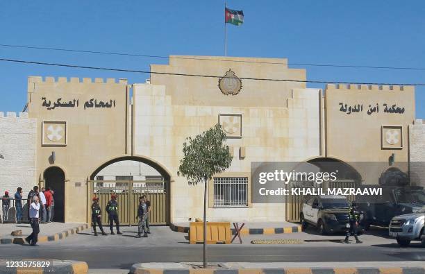 Policemen stand guard outside the State Security Court, where the trial of two officials accused of helping Jordan's Prince Hamzah try to overthrow...