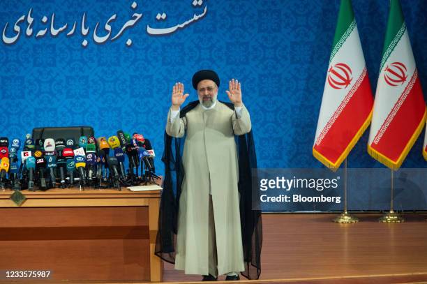 Ebrahim Raisi, Iran's president, waves to the media during his first news conference following his victory in the presidential election in Tehran,...