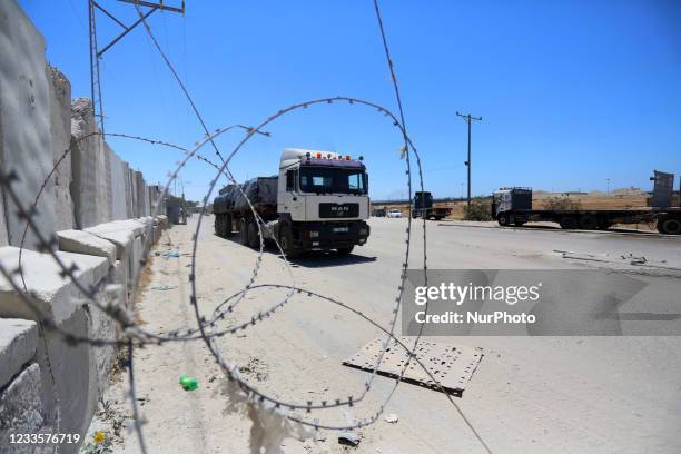 Truck carrying rice enters Gaza at the Kerem Shalom cargo crossing with Israel, in Rafah, southern Gaza Strip, Monday, June 21, 2021. Israel on...