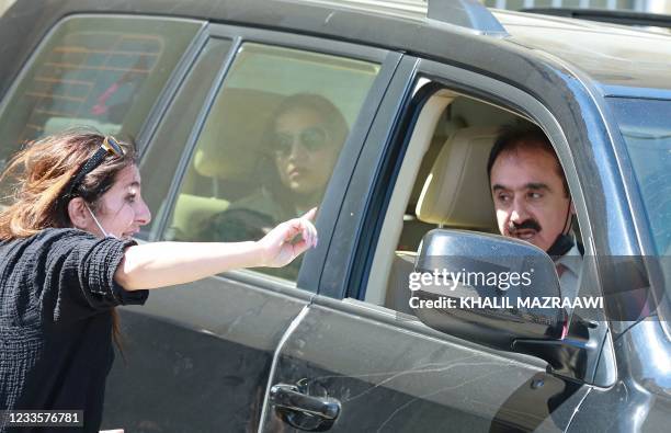 Reporter tries to speak with defence lawyer Mohammad Afif outside the State Security Court, where the trial of two officials accused of helping...