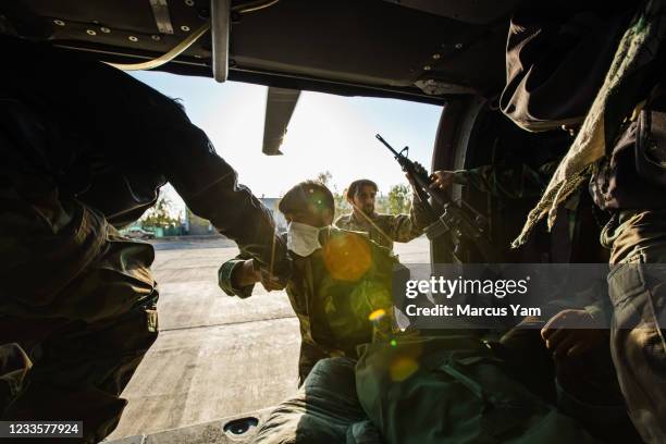 Soldiers depart a UH-60 Blackhawk after it lands at an outpost near Kandahar, Afghanistan, Thursday, May 6, 2021. The Afghan Air Force, which the...