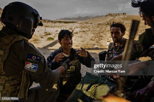 Soldiers from an outpost in the Shah Wali Kot district, board the UH-60 Blackhawk under fire from the Taliban, which has surrounded many government...