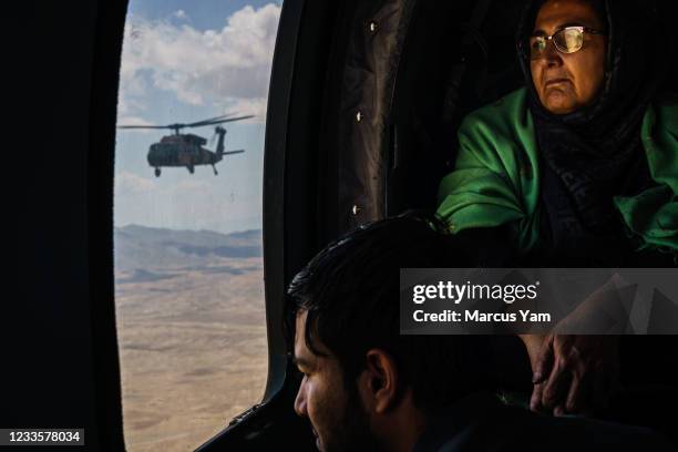 Hosy Andar, deputy Governor of Ghazni province, top, and other soldiers are transported back from at an outpost in Ghazni Province, to Kabul Airbase,...