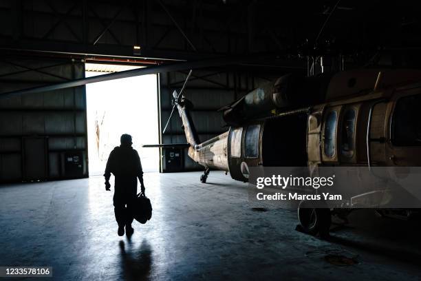 Col. Salim Razmindah walks towards his aircraft to begin his mission from Kabul Airbase, in Kabul, Afghanistan, Sunday, May 9, 2021. The Afghan Air...