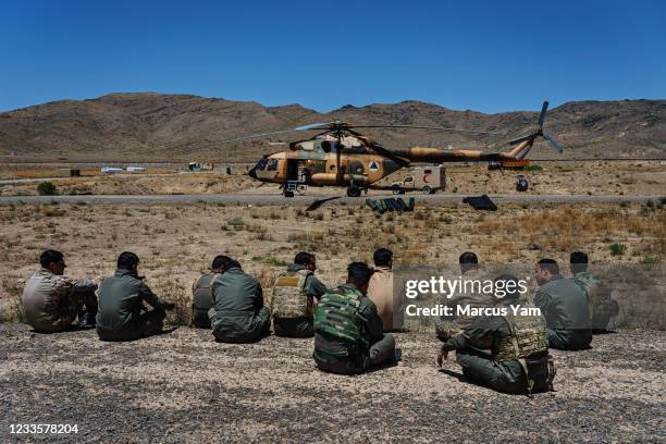 Col. Salim Razmindah, center left, and other aircrew get some rest at an outpost in Ghaniz province, Afghanistan, Sunday, May 9, 2021. The Afghan Air...