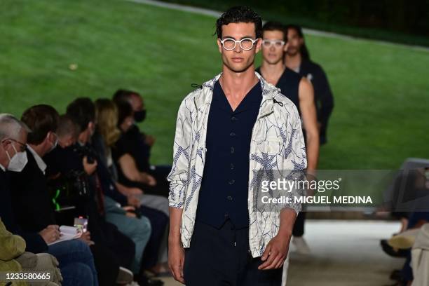 Models present creations for Giorgio Armani's Men's Spring Summer 2022 fashion collection on June 21, 2021 during the Milan Fashion Week.
