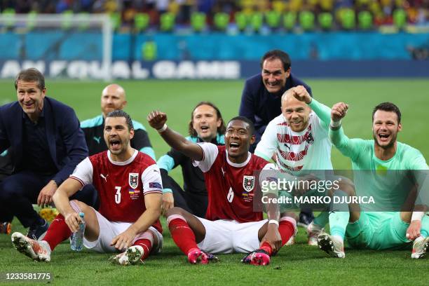 Austria's players celebrate after winning the UEFA EURO 2020 Group C football match between Ukraine and Austria at the National Arena in Bucharest on...