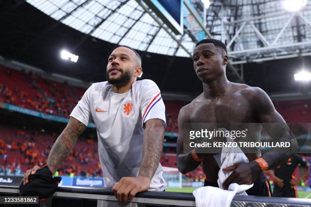 Netherlands' forward Memphis Depay and Netherlands' midfielder Quincy Promes speak to fans at the end of the UEFA EURO 2020 Group C football match...