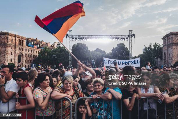 Supporter of Nikol Pashinian holds an Armenian flag during Nikol Pashinyan's victory celebration in Armenia's parliamentary elections in Yerevan's...