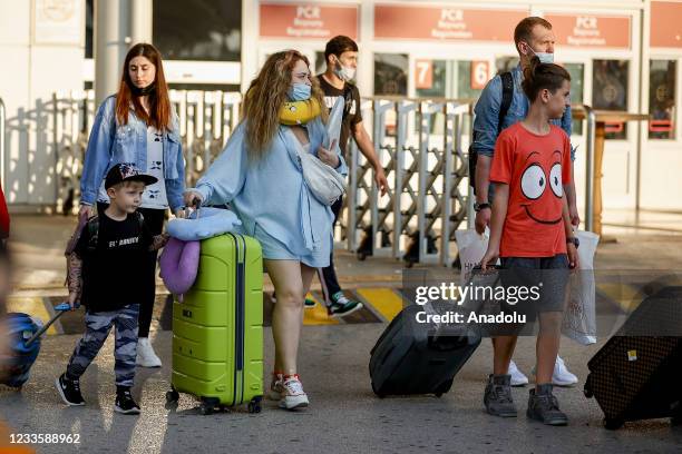 First tourist group from Russia take their luggages following arrival after Russia removed the 2-month flight restriction amid coronavirus in...