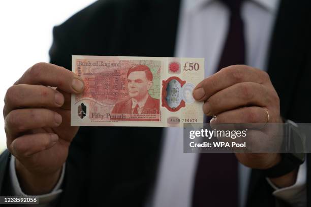 Governor of the Bank of England, Andrew Bailey with the new £50 note which features Alan Turing, at Bletchley Park on June 21, 2021 in Milton Keynes,...