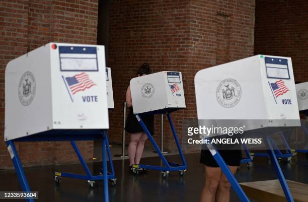 Residents vote during the New York City mayoral primary election at the Brooklyn Museum polling station on June 22, 2021 in New York City. - New York...