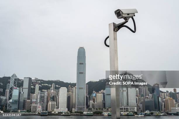 The CCTV camera monitor is set in front of the city skyline at the Vitoria Harbour in Hong Kong.