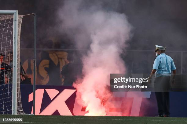 Fans of Esperance light up flares as they cheer for their team during the first leg CAF champions league semi-final football match between Tunisia's...