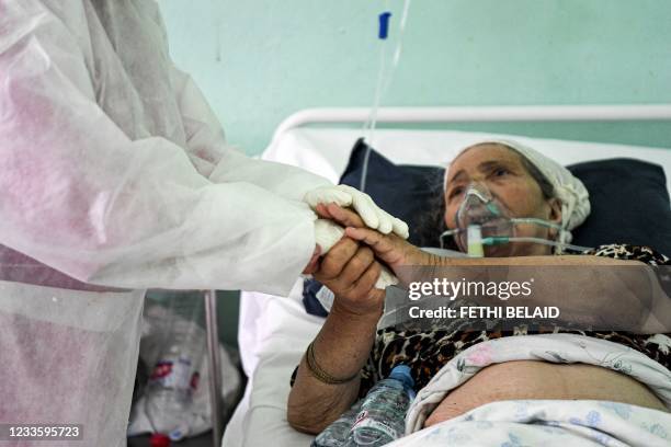 Tunisian woman receiving treatment after being infected by the Covid-19, thanks a doctor at an intensive care unit in a hospital in the northwestern...