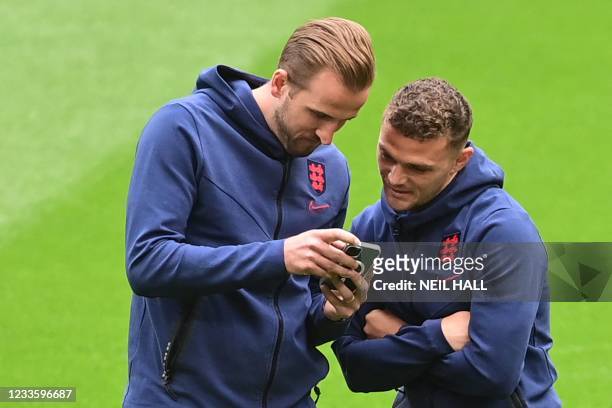 England's forward Harry Kane and England's defender Kieran Trippier look at Kane's phone prior to the UEFA EURO 2020 Group D football match between...