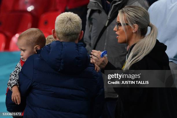 England's midfielder Phil Foden and his partner Rebecca Cooke are seen in the stands at the end of the UEFA EURO 2020 Group D football match between...