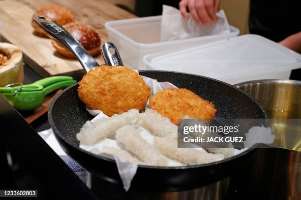 Chef prepares burgers and rice rolls made with "cultured chicken" meat at a restaurant adjacent to the SuperMeat production site in the central...