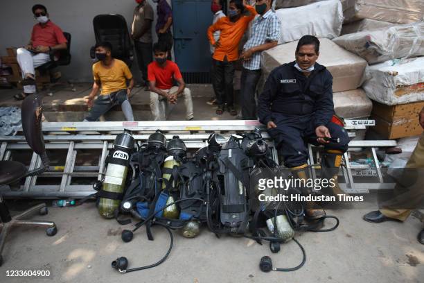 Firefighter next to equipment during dousing operations at a footwear factory in Udyog Nagar, on June 21, 2021 in New Delhi, India. A massive fire...