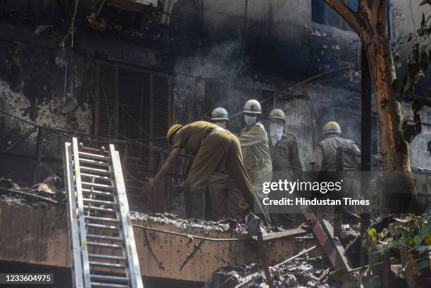 Firefighters working to douse a fire in a footwear factory in Udyog Nagar, on June 21, 2021 in New Delhi, India. A massive fire broke out at a shoe...