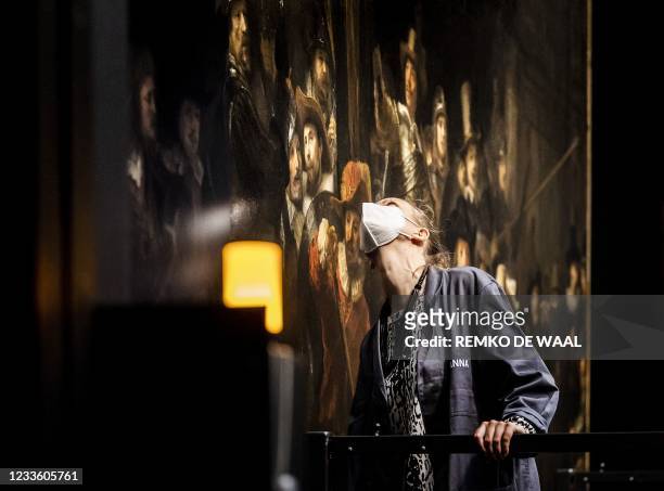 An employee looks at the work on the 1642 'Night Watch' at the Rijksmuseum Museum during 'Operation Night Watch', the largest ever investigation into...
