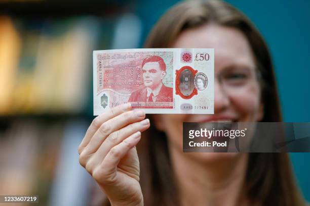 Sarah John, chief cashier of the Bank of England, poses with a new 50-pound banknote at Daunt Books on June 23, 2021 in London, England. The new £50...
