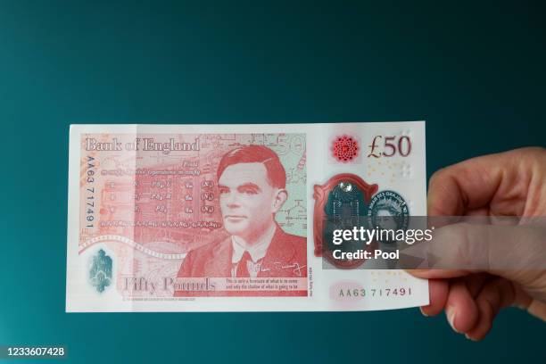 Sarah John, chief cashier of the Bank of England, poses with a new 50-pound banknote at Daunt Books on June 23, 2021 in London, England. The new £50...