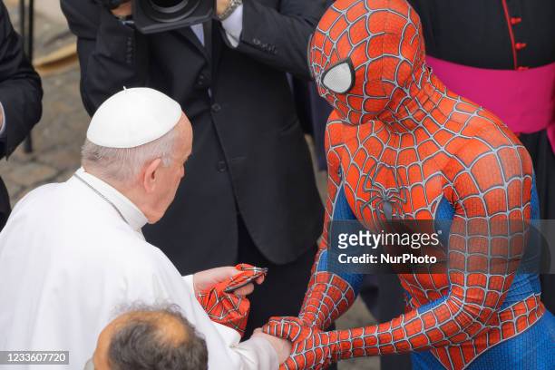 Pope Francis meets Spider-Man, who presents him with his mask, at the end of his weekly general audience with a limited number of faithful in the San...