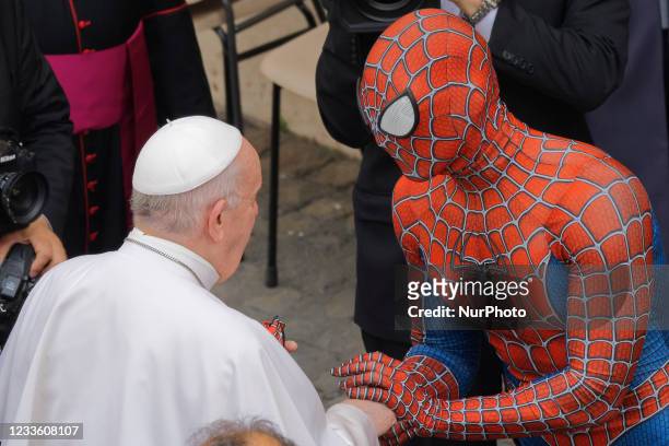 Pope Francis meets Spider-Man, who presents him with his mask, at the end of his weekly general audience with a limited number of faithful in the San...