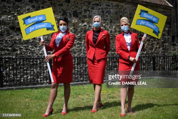 Representatives from the travel industry, including airline cabin crew From Virgin Atlantic, demonstrate during a 'Travel Day of Action' outside the...