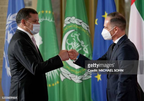 German Foreign Minister Heiko Maas welcomes Libyan Prime Minister Abdul Hamid Dbeibah for the Second Berlin Conference on peace in Libya at the...