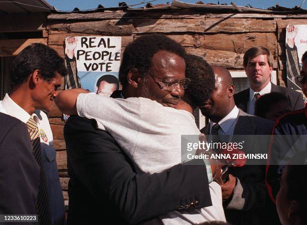 Dr Mangosuthu Buthelezi, leader of the Inkatha Freedom Party gets a hug from an enthusiastic supporter while visiting the Tafelsig informal...