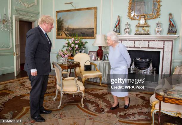 Queen Elizabeth II greets Prime Minister Boris Johnson during the first in-person weekly audience with the Prime Minister since the start of the...