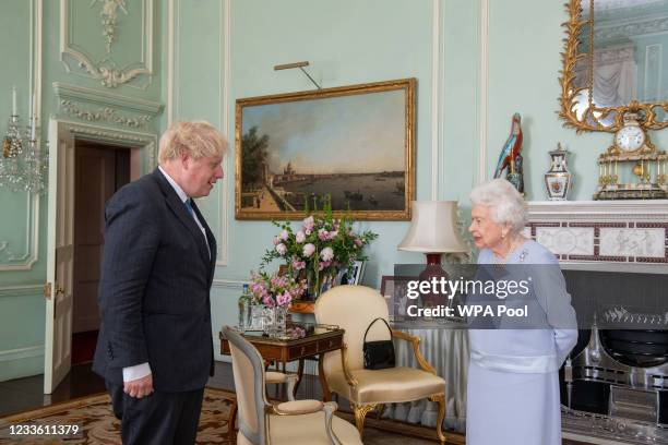 Queen Elizabeth II greets Prime Minister Boris Johnson during the first in-person weekly audience with the Prime Minister since the start of the...