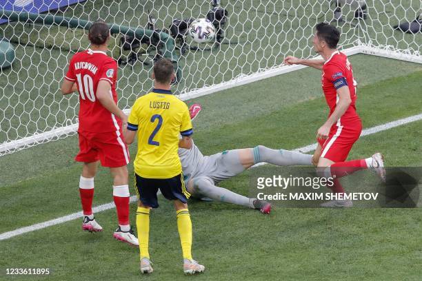 Poland's forward Robert Lewandowski heads teh ball and hits the goal post during the UEFA EURO 2020 Group E football match between Sweden and Poland...